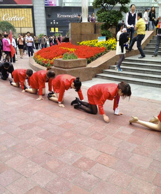 Illustration for article titled Chinese Employees Made To Crawl in Public